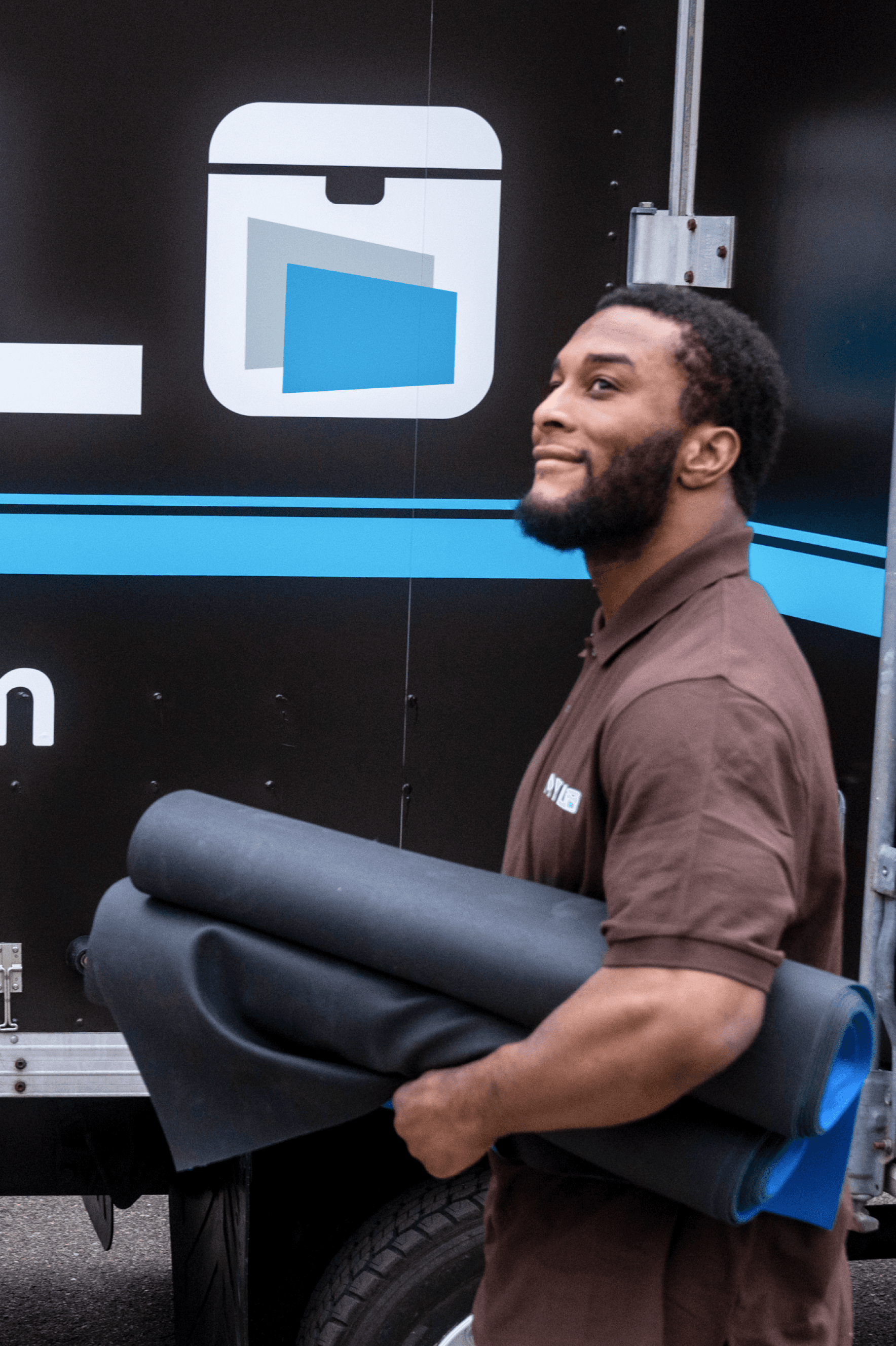 MYLO mover carrying moving pads beside the MYLO truck